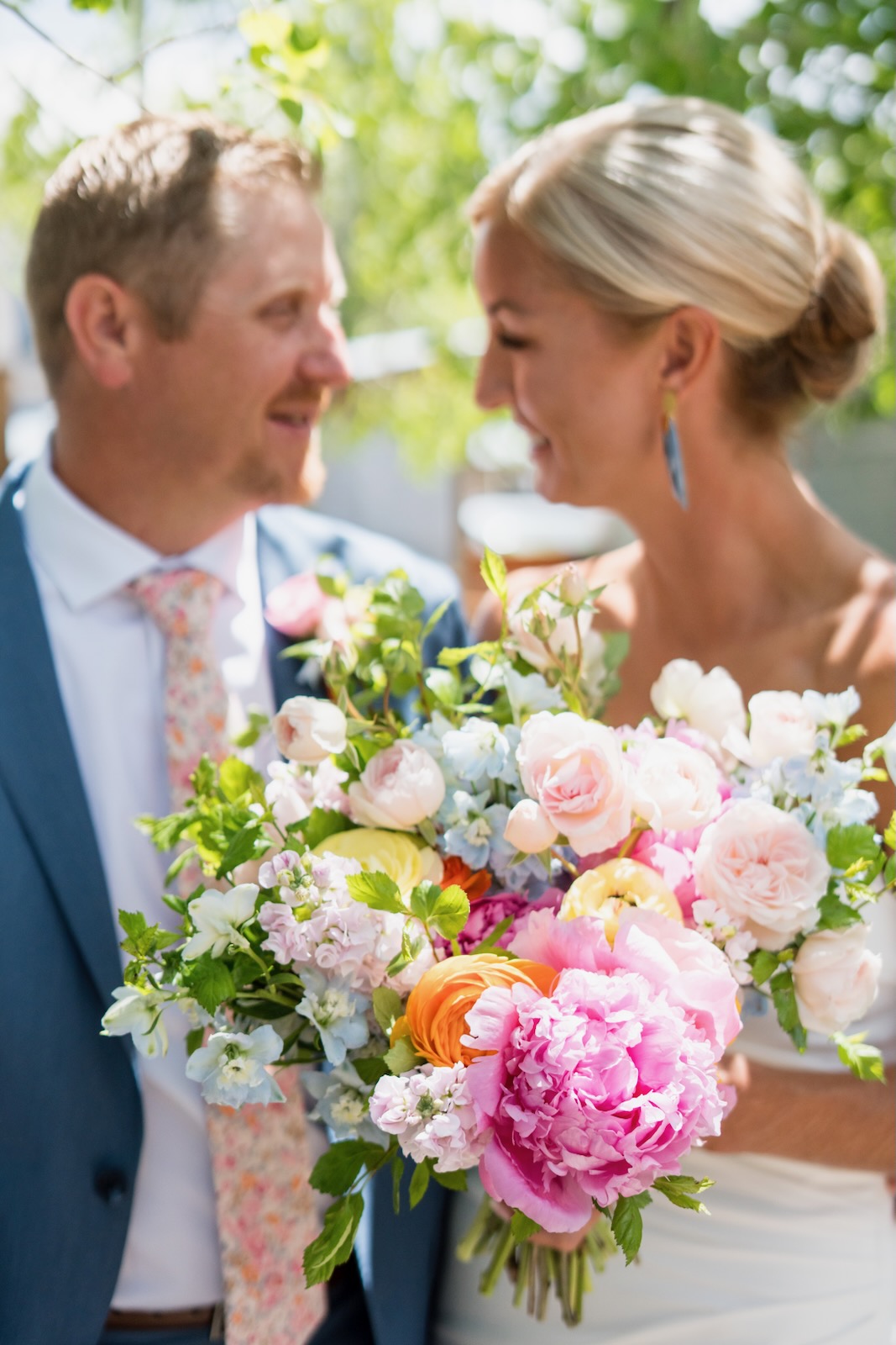 Couple sharing a first look with lush pastel bouquet