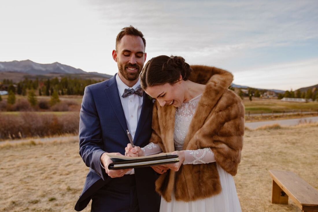A Colorado marriage license laid out on a wooden surface with a pen.